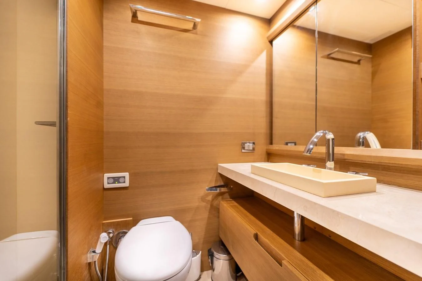 a bathroom with a sink toilet and a mirror aboard LEONARDO 98 Yacht for Sale