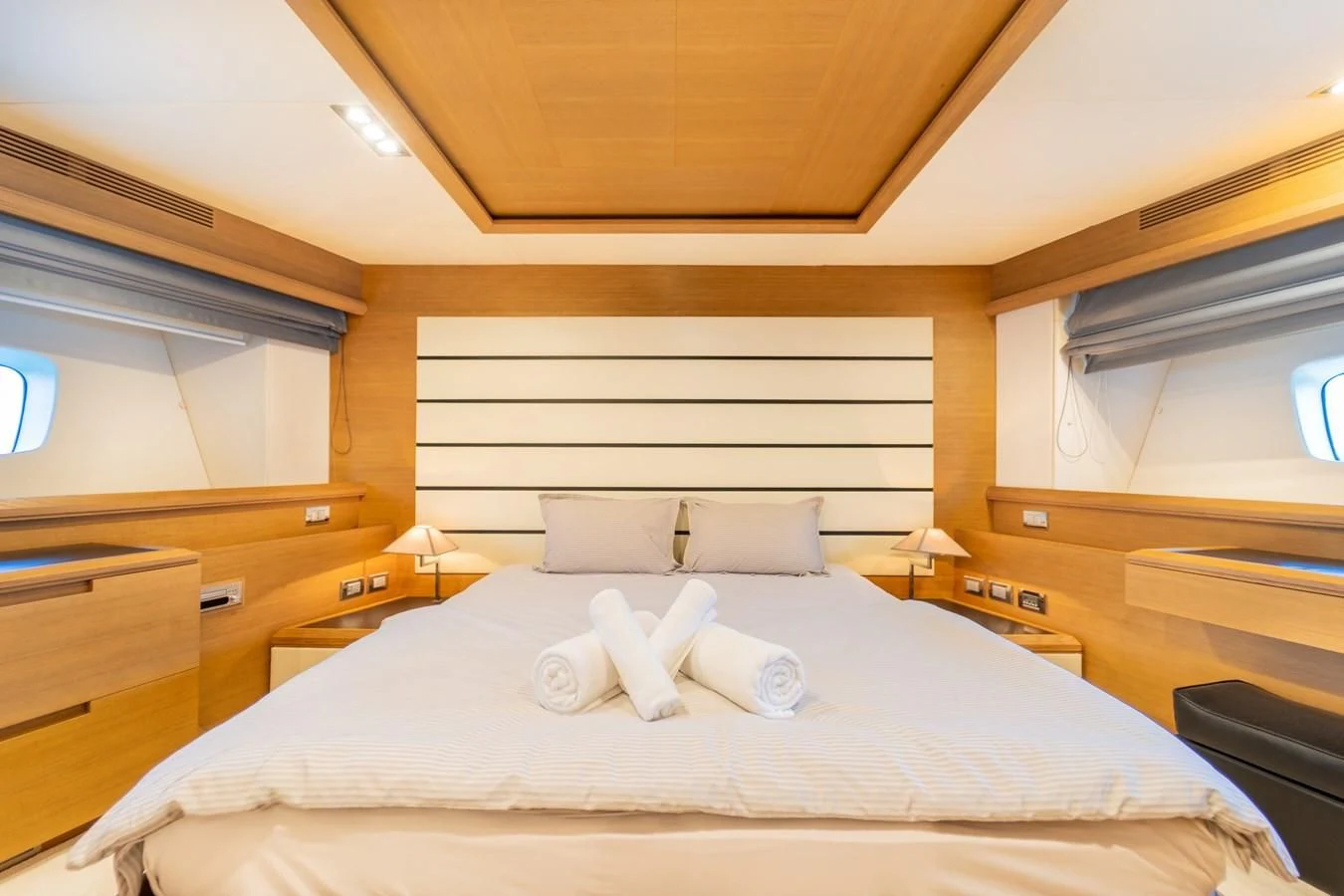 a bed with white sheets aboard LEONARDO 98 Yacht for Sale