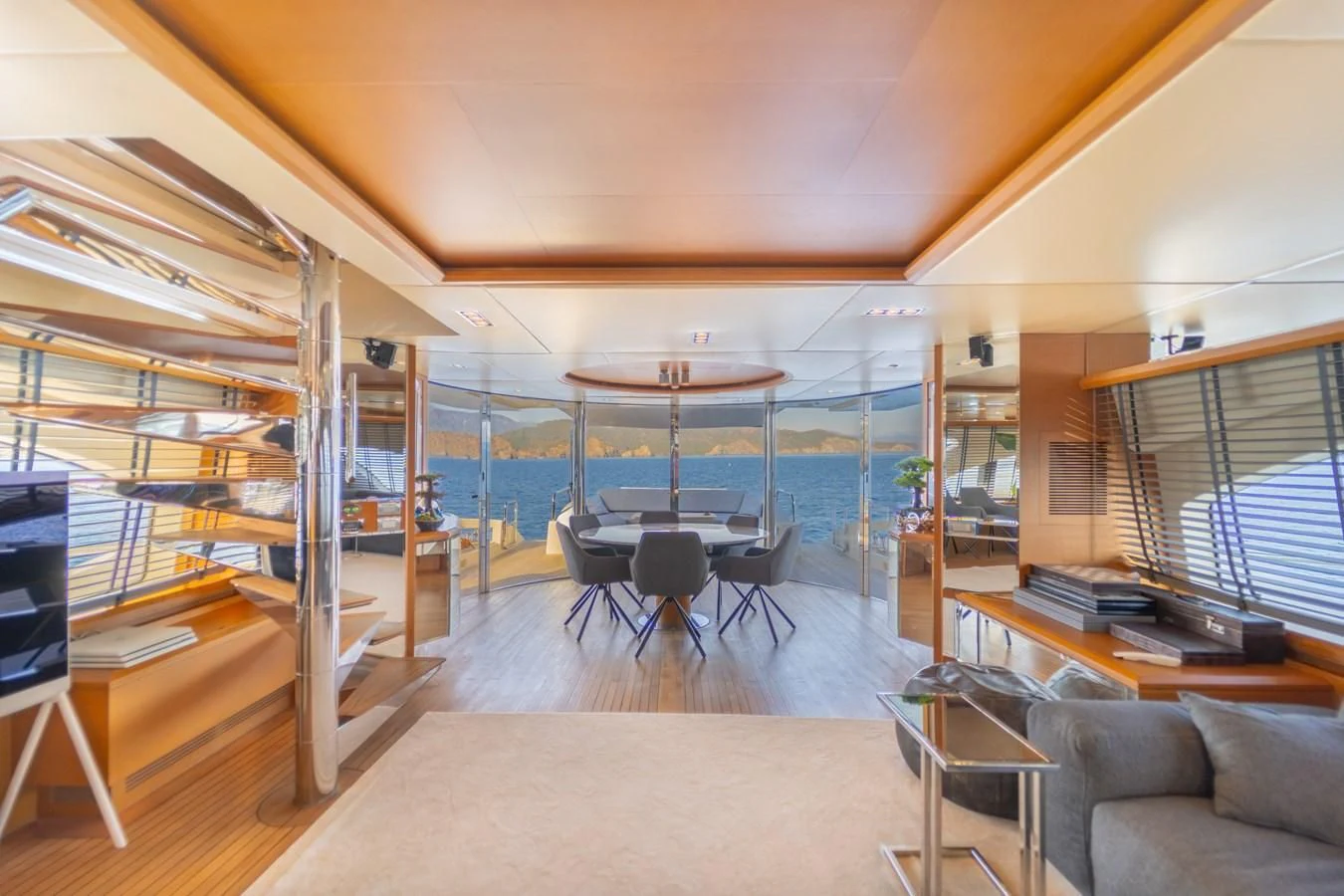 a room with a table and chairs aboard LEONARDO 98 Yacht for Sale