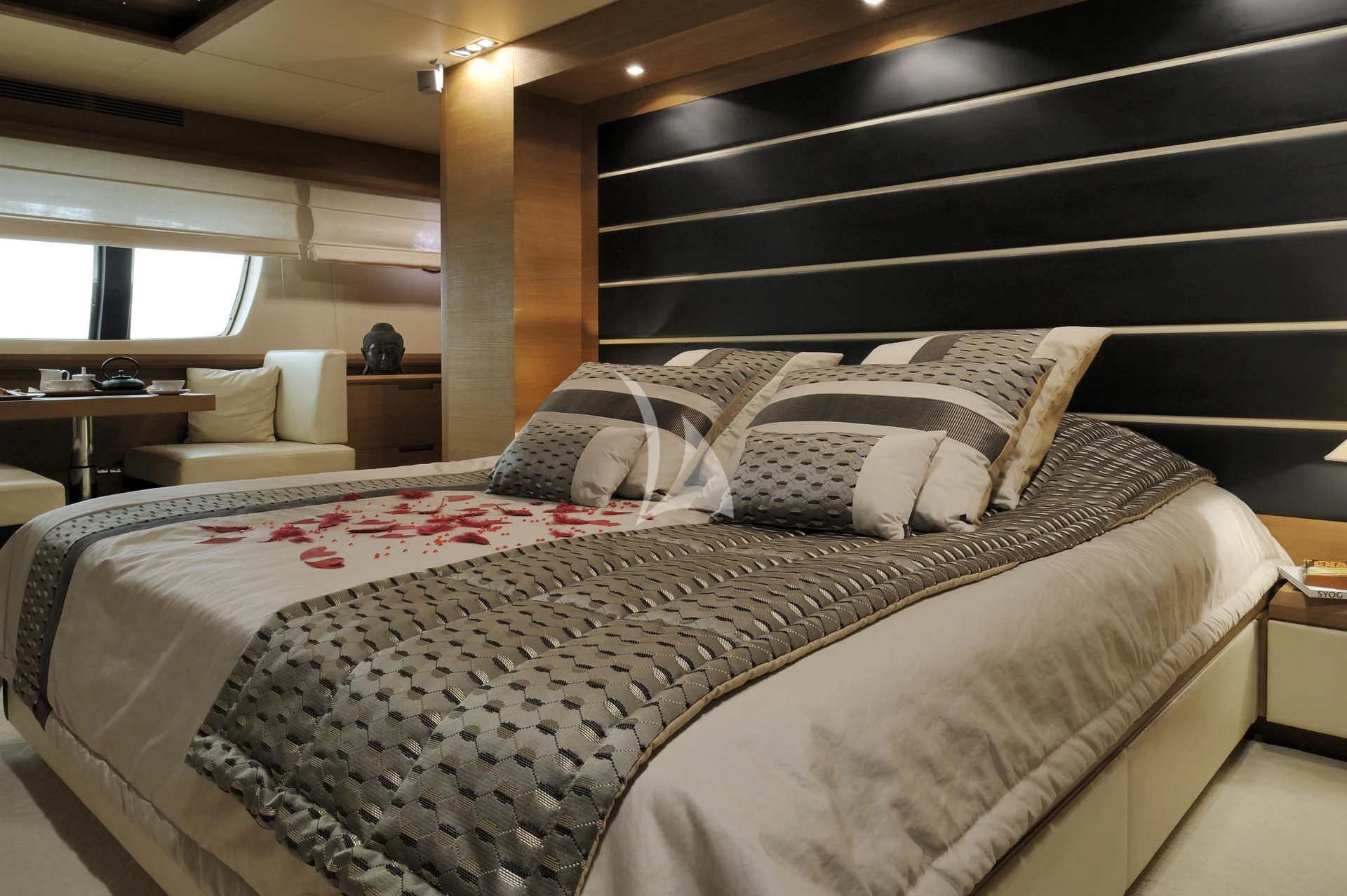a bed with a white comforter aboard LEONARDO 98 Yacht for Sale