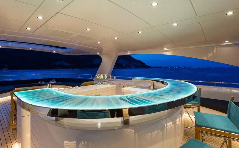 a pool with blue chairs aboard LA PASSION Yacht for Sale