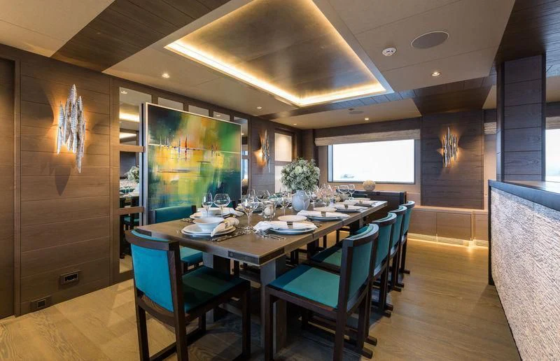 a dining room with a table and chairs aboard LA PASSION Yacht for Sale