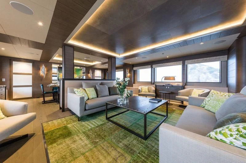 a living room with a table and couches aboard LA PASSION Yacht for Sale