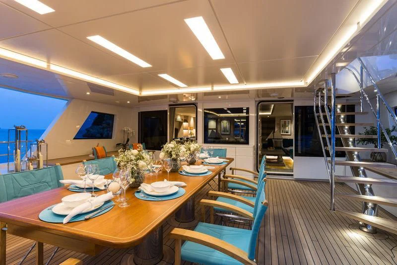 a room with a table chairs and a television aboard LA PASSION Yacht for Sale