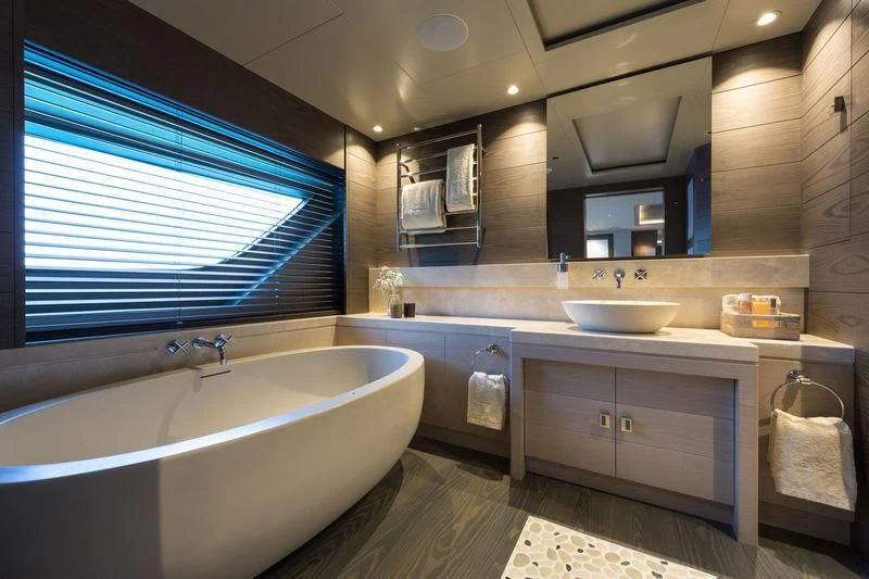 a bathroom with a tub sink and cabinets aboard LA PASSION Yacht for Sale