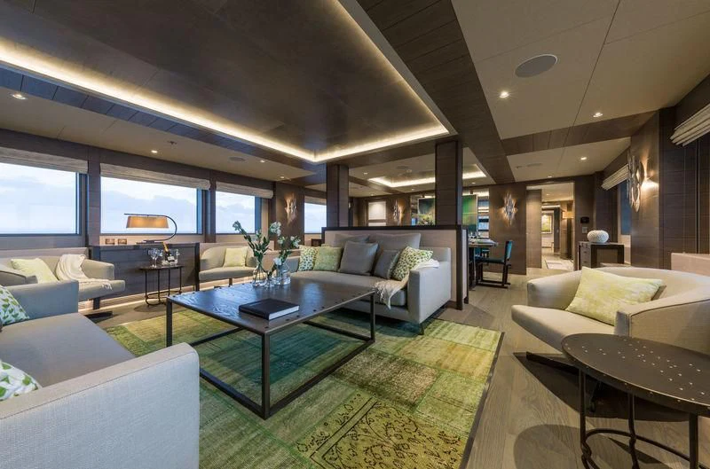 a living room with a table and couches aboard LA PASSION Yacht for Sale