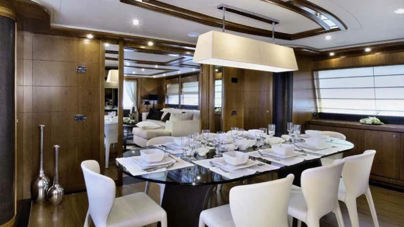 a dining room with a table set aboard SIMA Yacht for Sale