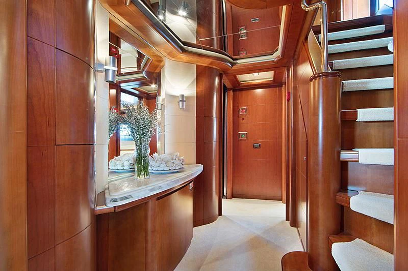 a room with a table and a plant in it aboard SIMA Yacht for Sale