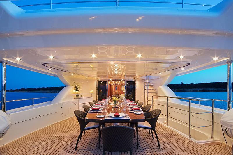 a room with a table and chairs aboard SIMA Yacht for Sale