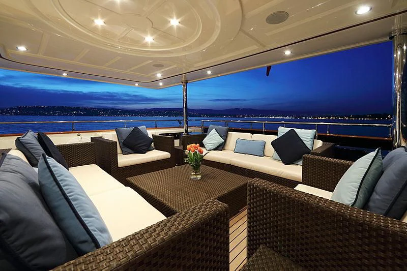 a large boat with a large body of water in the background aboard SIMA Yacht for Sale