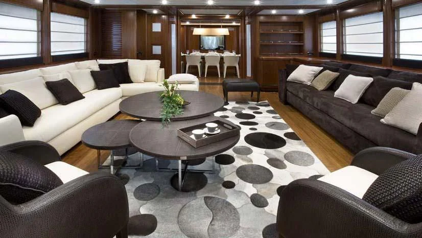 a living room with a couch and coffee table aboard SIMA Yacht for Sale