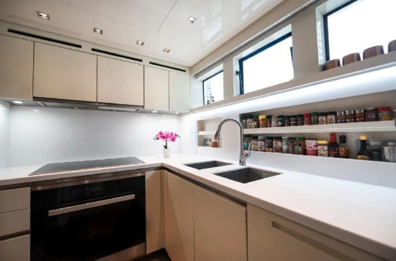 a kitchen with white cabinets aboard RAYEN Yacht for Sale