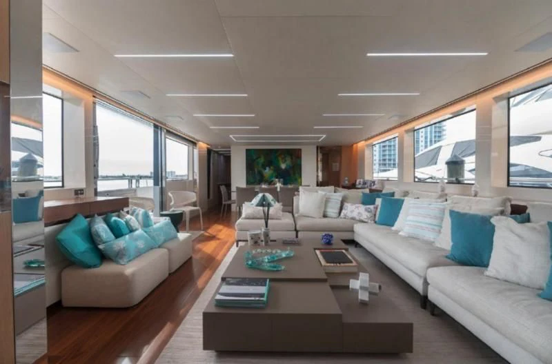 a living room with a couch and a coffee table aboard RAYEN Yacht for Sale