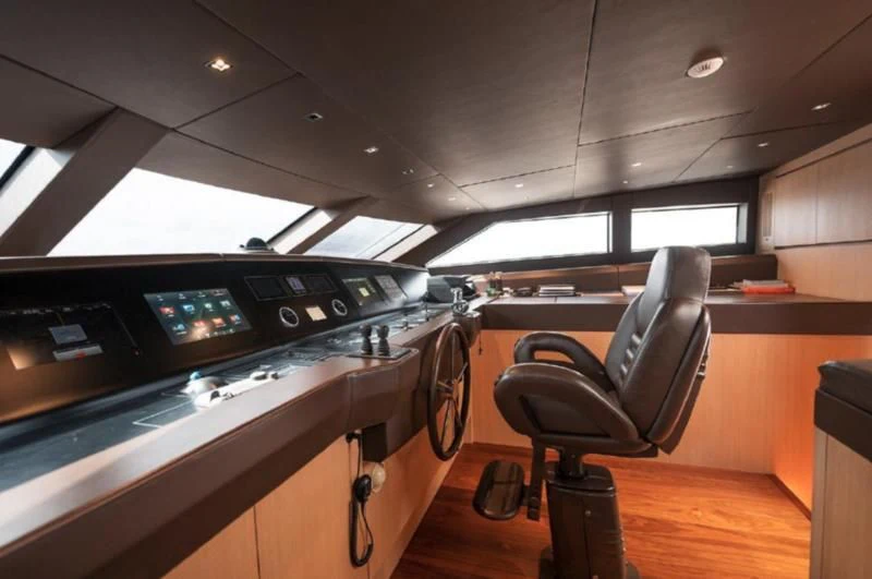 a room with a desk and chairs aboard RAYEN Yacht for Sale