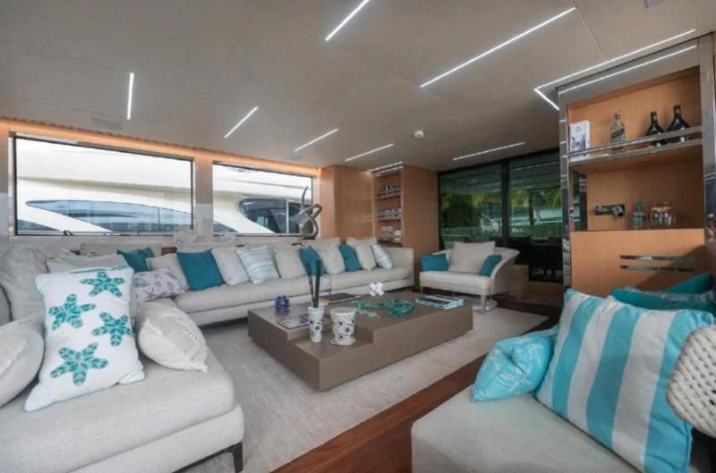 a living room with couches and a coffee table aboard RAYEN Yacht for Sale
