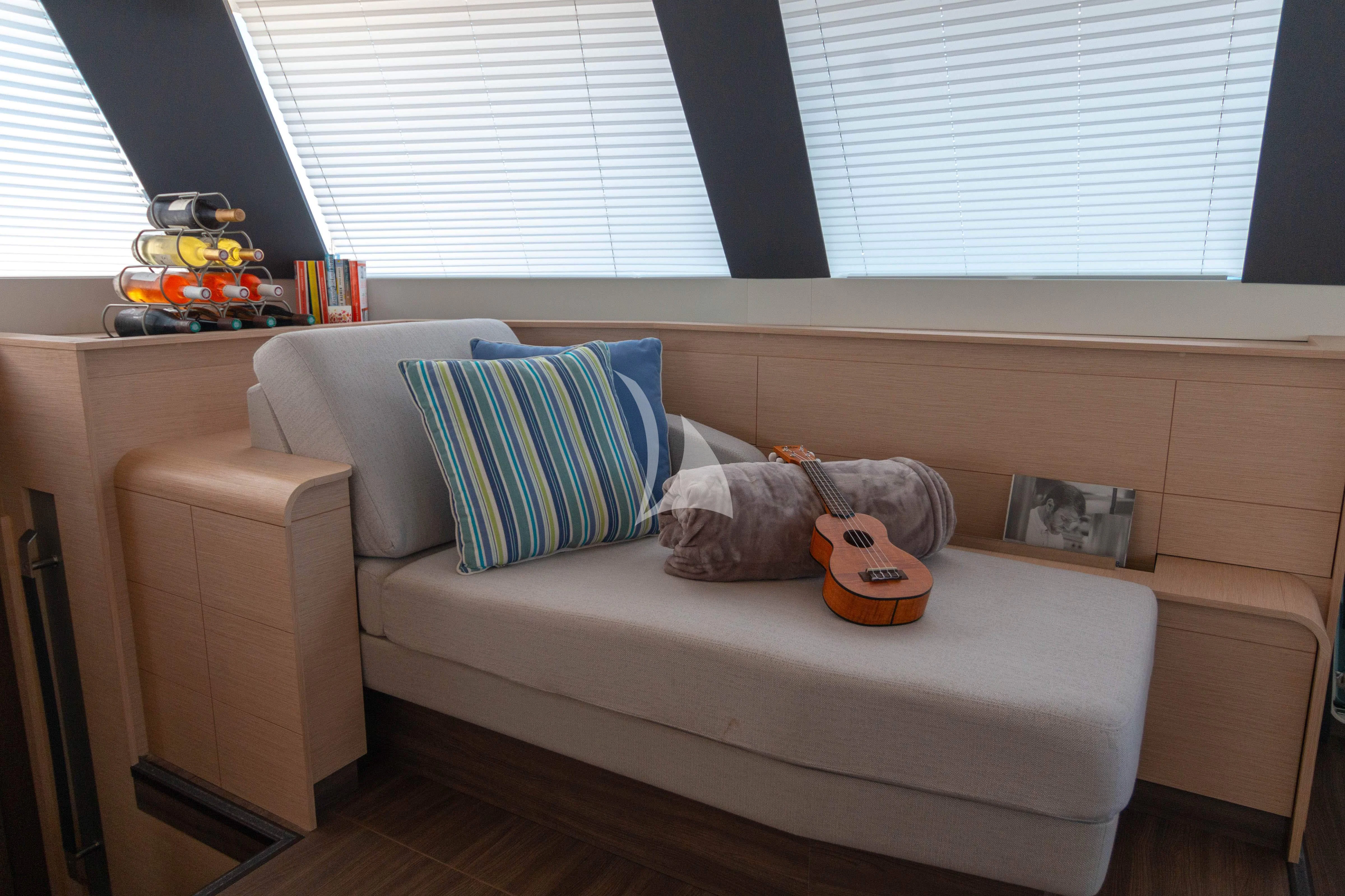 a couch with a pillow and a stuffed animal on it aboard SERENISSIMA Yacht for Charter