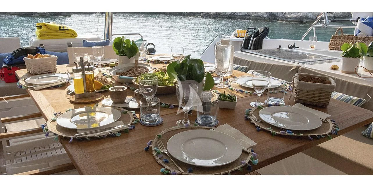 a table with plates and glasses on it aboard SERENISSIMA Yacht for Charter