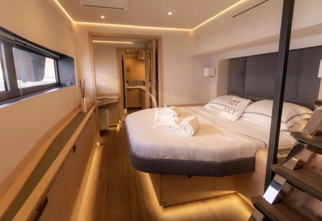 a room with a bed and a television aboard SERENISSIMA Yacht for Charter