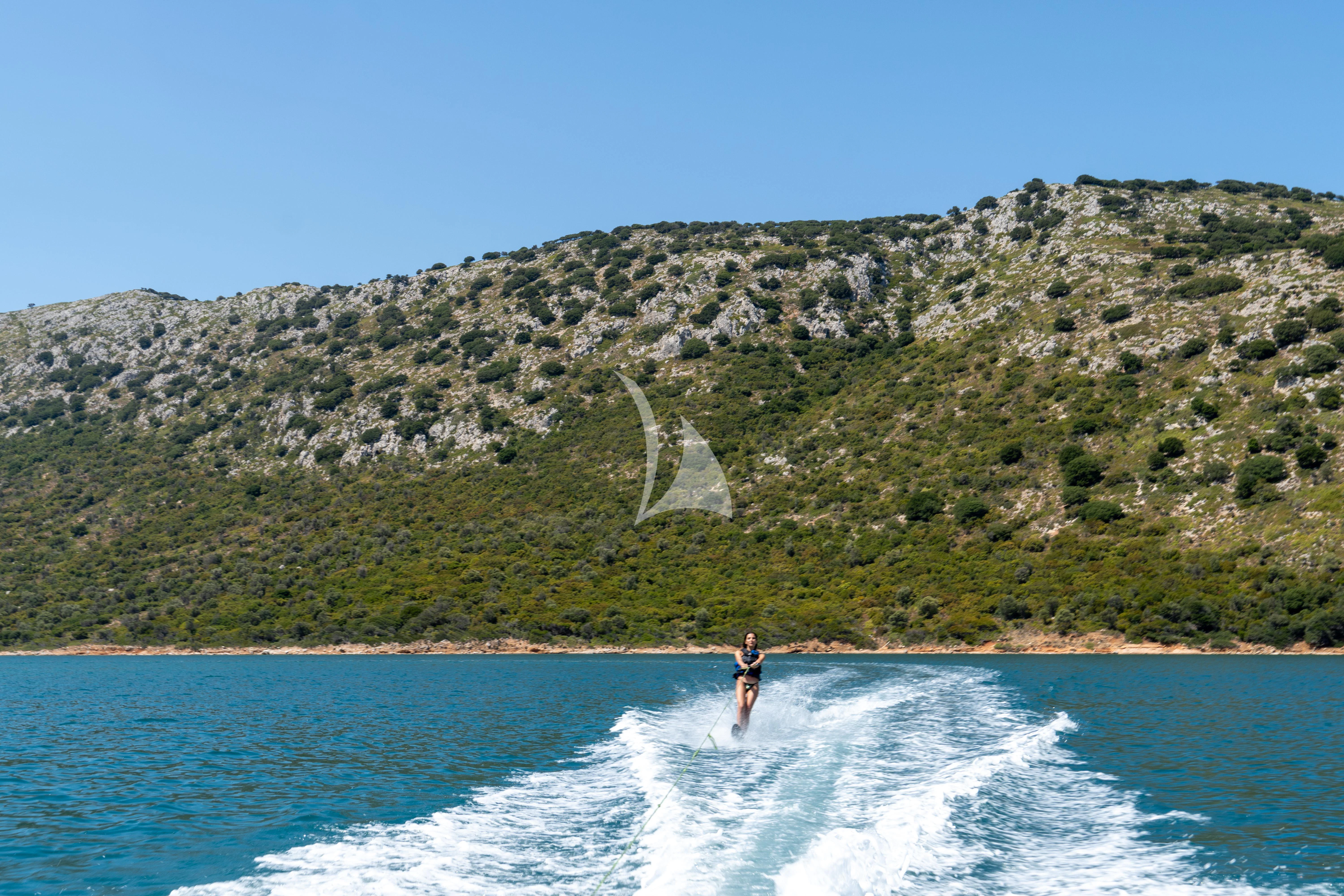 a person riding a surfboard in the water aboard SERENISSIMA Yacht for Charter