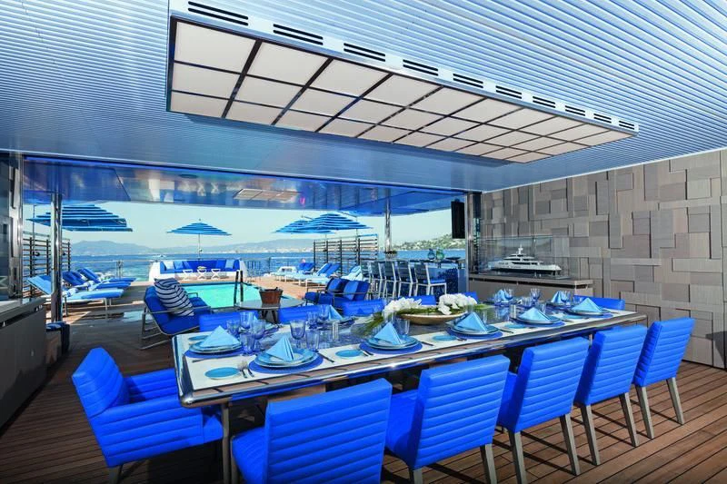 a room with tables and chairs aboard SEASENSE Yacht for Sale