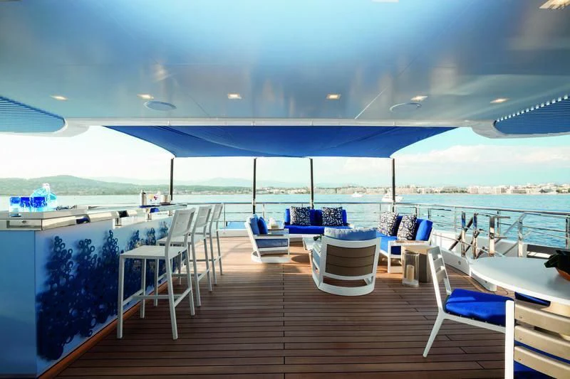 a deck with chairs and tables aboard SEASENSE Yacht for Sale