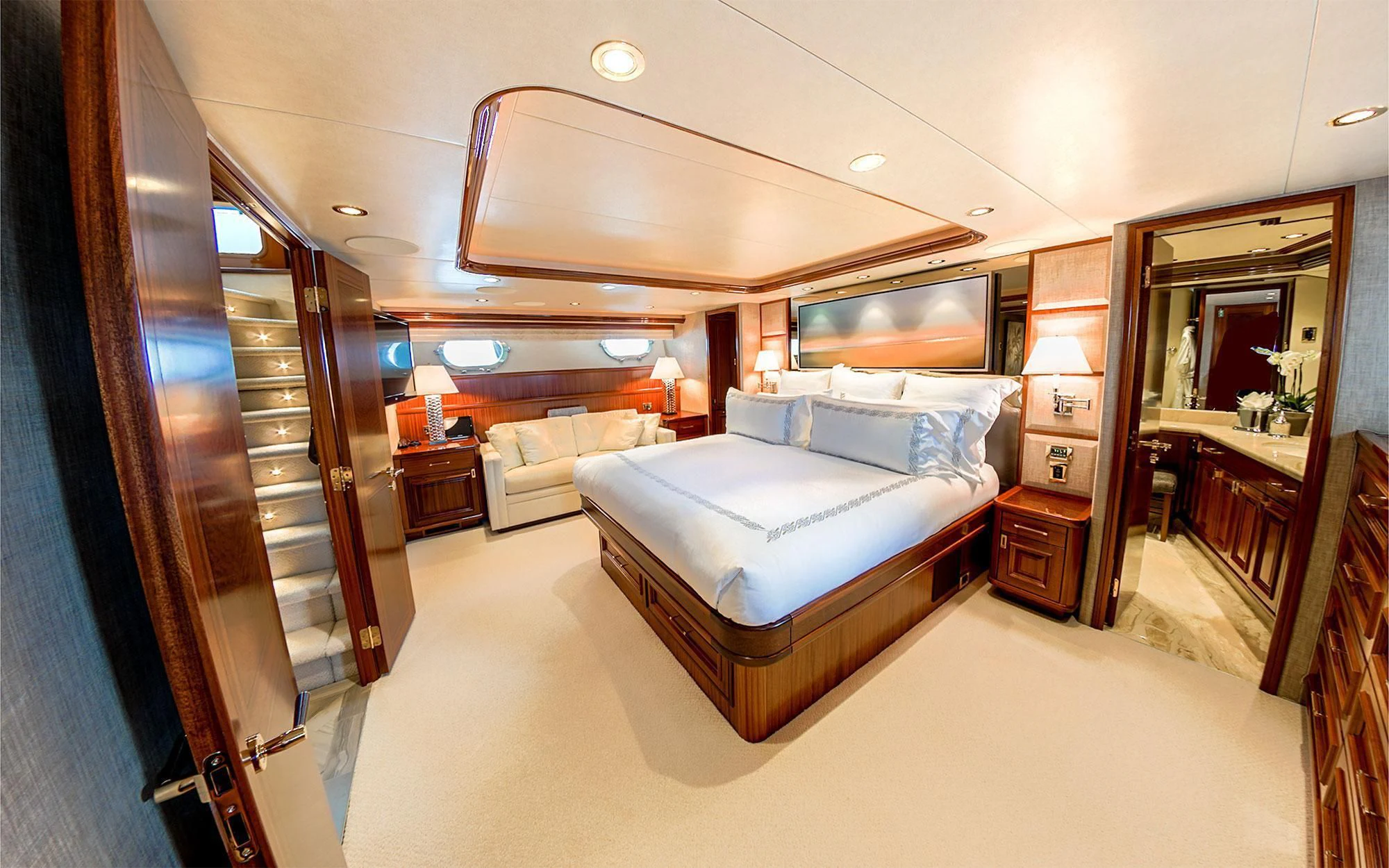 a bedroom with a bed and a mirror aboard SEASENSE Yacht for Sale
