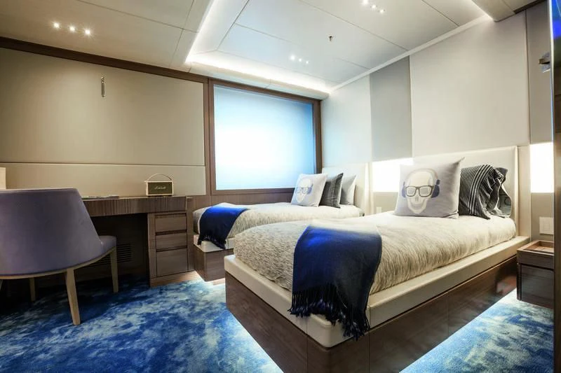 a bedroom with a bed and a desk aboard SEASENSE Yacht for Sale