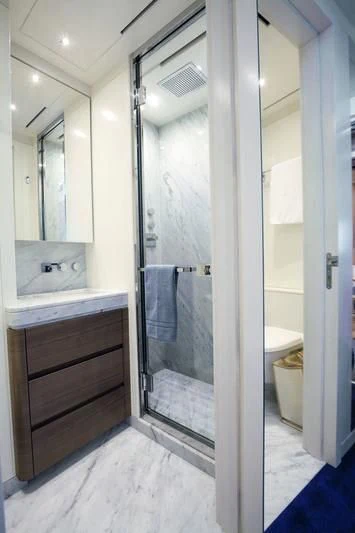 a bathroom with a glass shower aboard SEASENSE Yacht for Sale
