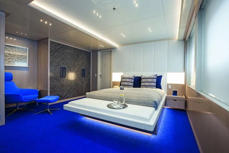 a room with a bed and a chair aboard SEASENSE Yacht for Sale