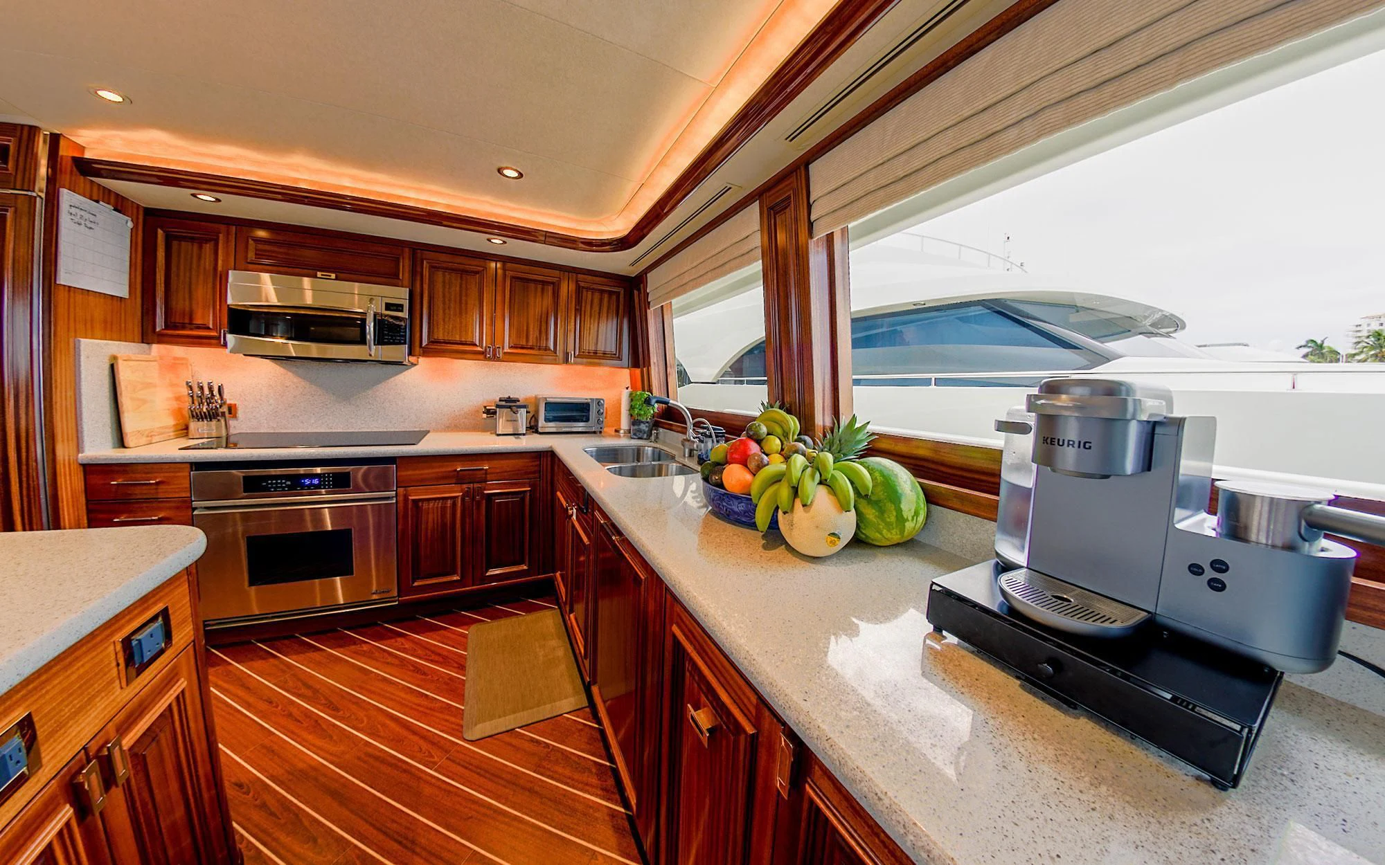 a kitchen with a large window aboard SEASENSE Yacht for Sale