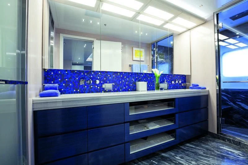 a bathroom with blue cabinets aboard SEASENSE Yacht for Sale