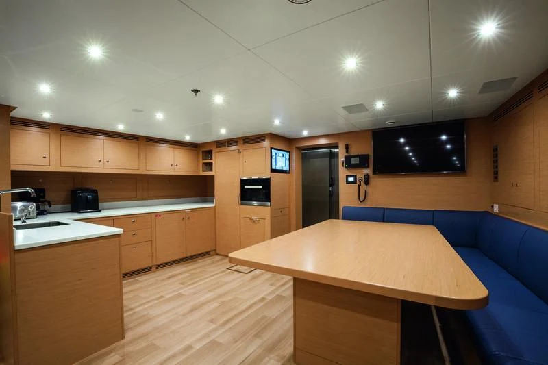 a kitchen with a table and a couch aboard SEASENSE Yacht for Sale