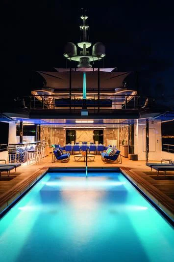 a pool with a table and chairs aboard SEASENSE Yacht for Sale