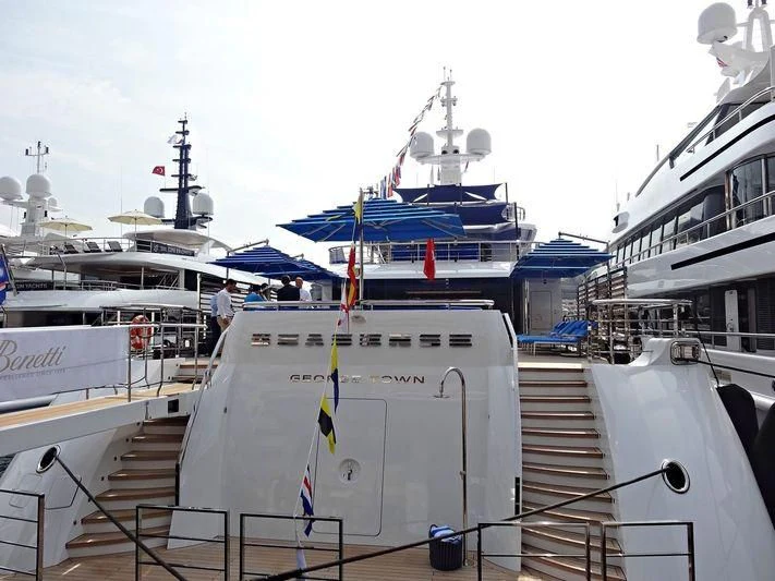 a large white ship with a blue and yellow stripe aboard SEASENSE Yacht for Sale