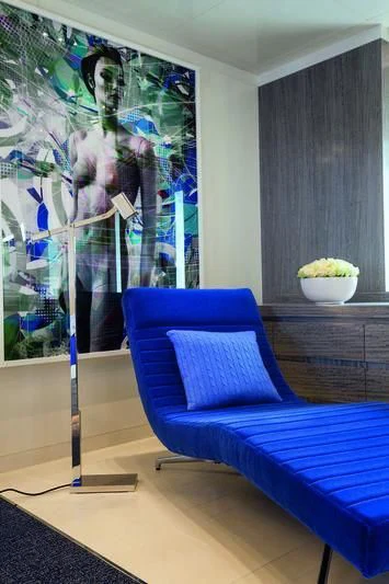 a blue couch in a room aboard SEASENSE Yacht for Sale