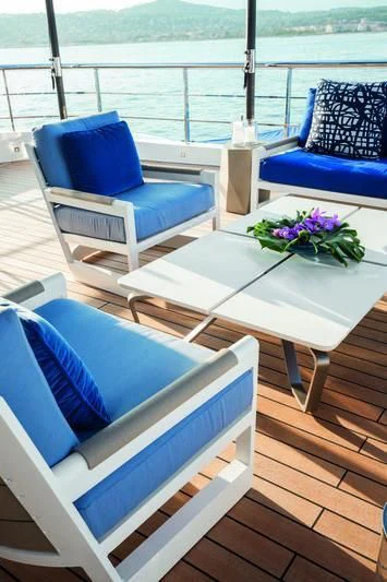 a table with chairs on it aboard SEASENSE Yacht for Sale