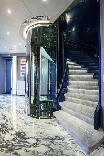 a hallway with stairs and a glass door aboard SEASENSE Yacht for Sale