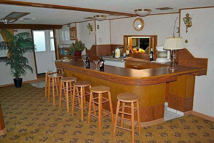 a kitchen with stools and a bar aboard ROSE Yacht for Sale