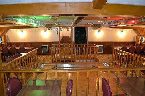 a large room with tables and chairs aboard ROSE Yacht for Sale