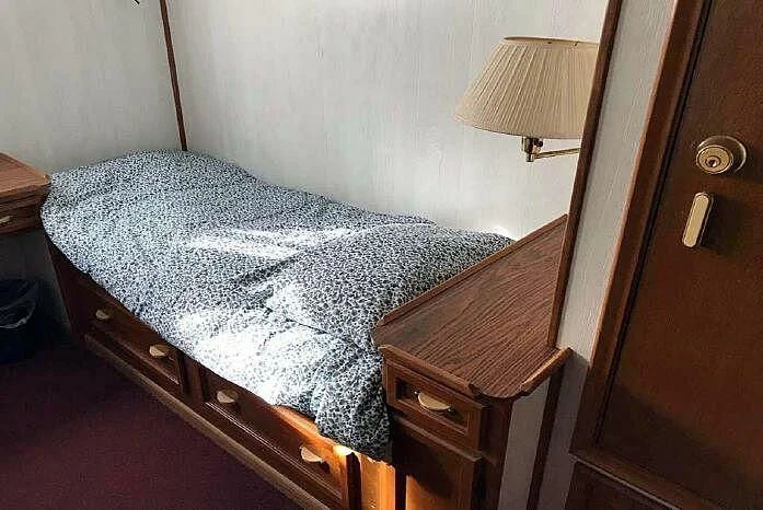a bed with a lamp on it aboard ROSE Yacht for Sale