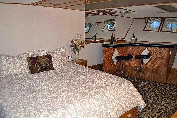 a bed with a white sheet aboard ROSE Yacht for Sale