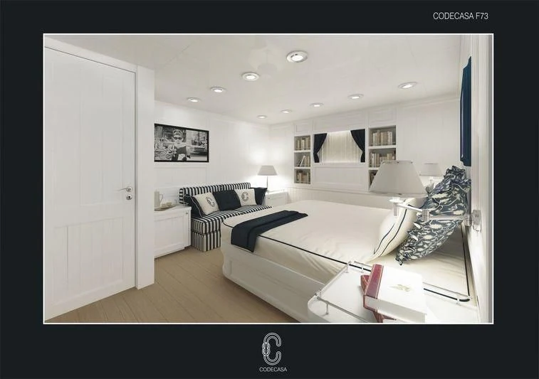 a bedroom with a bed and a desk aboard MAGARI Yacht for Sale