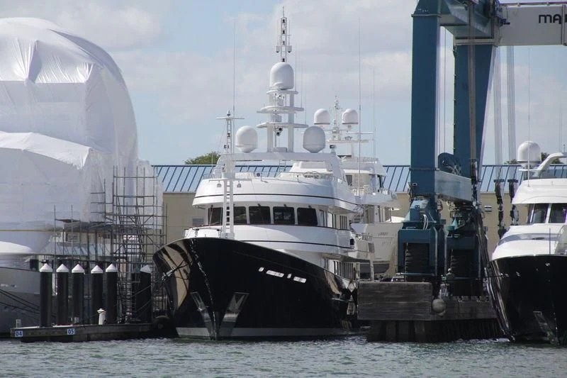 a large boat docked at a pier aboard MOONSHADOW Yacht for Sale