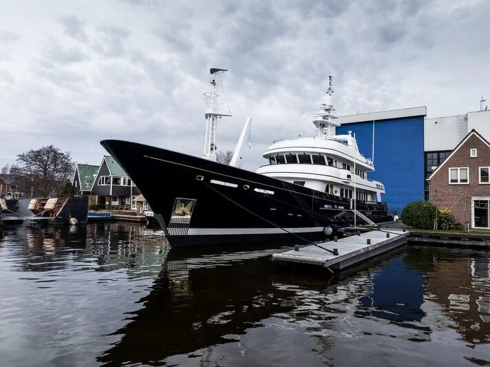 a large boat docked at a pier aboard MOONSHADOW Yacht for Sale