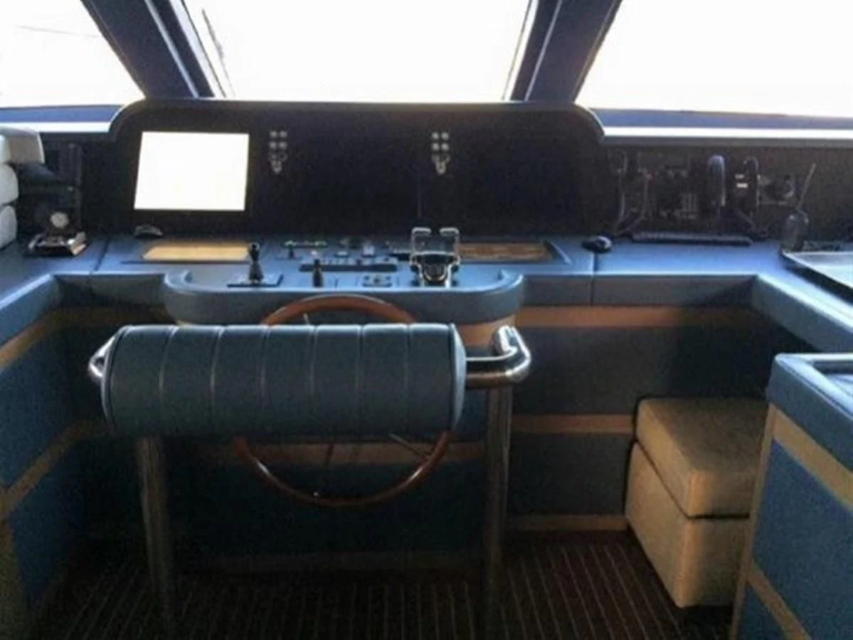 a large black piano with a wooden seat and a wooden chair in front of it aboard BENNETTI 105 Yacht for Sale