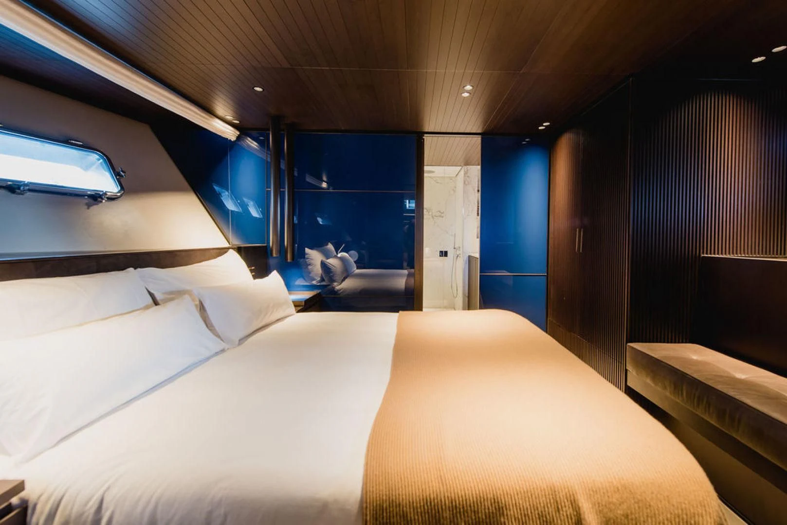 a room with a bed and a window aboard ZAZZAZU II Yacht for Sale
