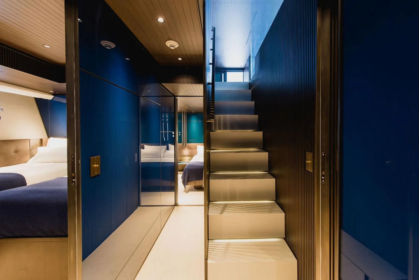 a hallway with blue doors aboard ZAZZAZU II Yacht for Sale