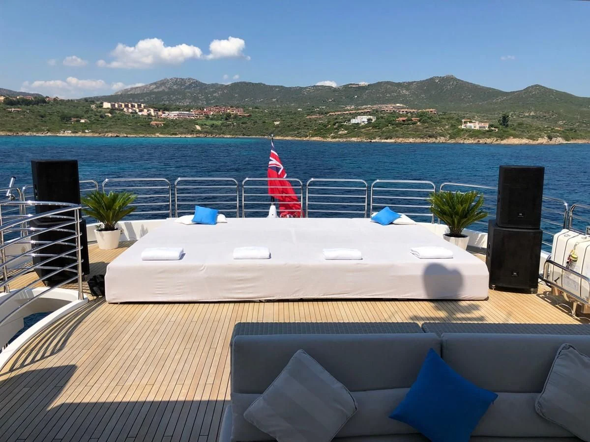 a table on a deck overlooking a body of water aboard REGULUS Yacht for Sale