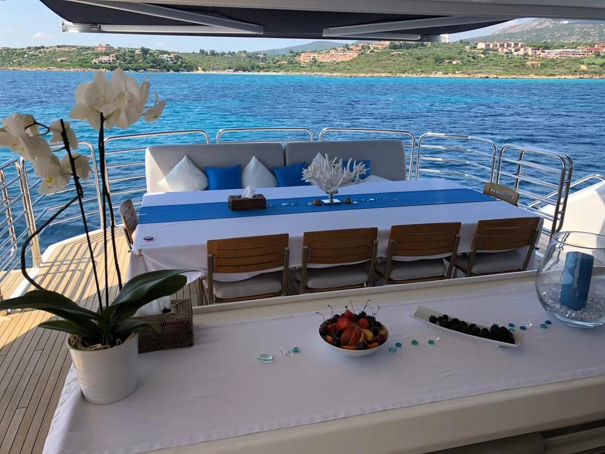 a table with chairs and a pool aboard REGULUS Yacht for Sale