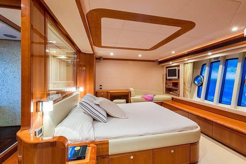 a bedroom with a bed and a window aboard MONTICELLO II Yacht for Sale
